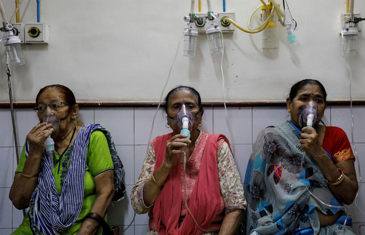 Women receive treatment for respiratory issues at a hospital in New Delhi. Reuters Photo 
