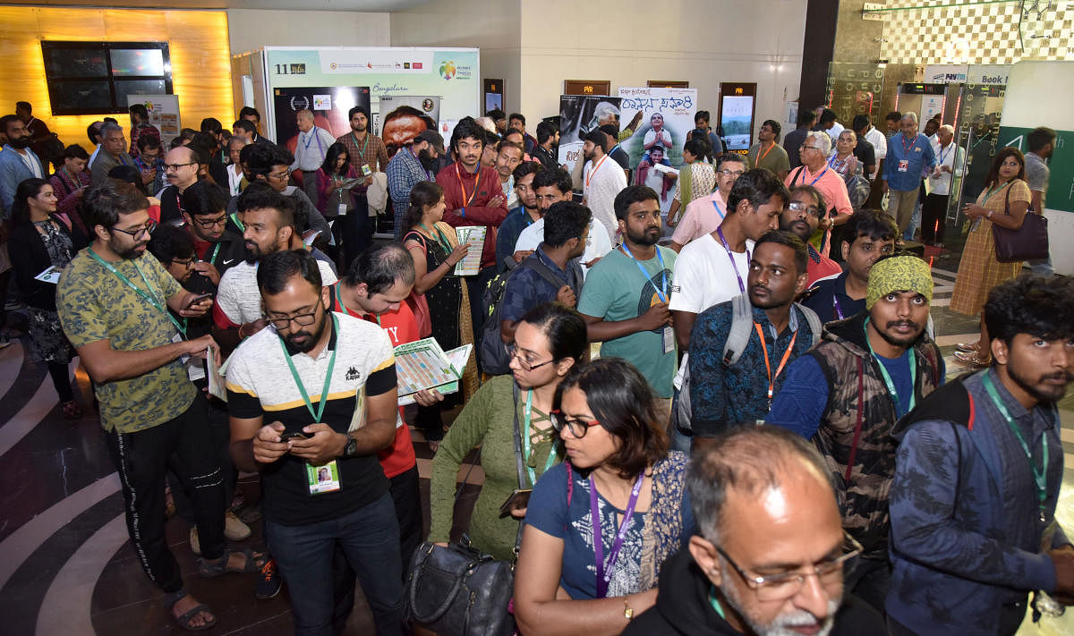 Audience standing in queue to watch their favourite films at BIFFes 2019. DH Photo by SK Dinesh