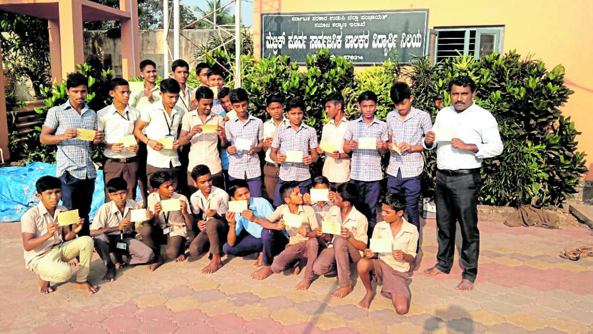 Students show letters written to the parents and guardians in Udupi.