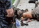 Rampage: Special Force officers at the scene of a bomb blast, with human body parts in the road in front of Chechen parliament complex in Grozny, southern Russia, on Tuesday. AP