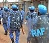 Rapid Action Force personnel along with policemen patrol a street a day after communal clash in Mysore. PTI