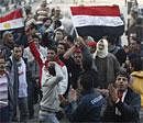 Egyptian protesters clap and wave flags in Tahrir Square in downtown Cairo on Sunday. AP