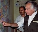 Minister of State for Forests and Environment Jairam Ramesh looking map of the wild life sanctuaries, in Chikmagalur, Karnataka on Sunday. PTI Photo