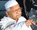 Anna Hazare addresses a press conference in Ralegan Siddhi, Ahmednagar, on Tuenesday. PTI
