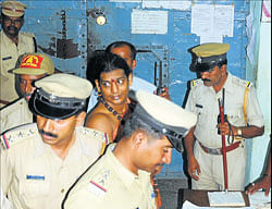 Cops at Central Prisons Mysore record the entry of prisoner Nithyananda, on Thursday. dh photo