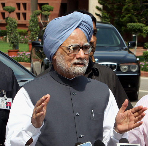 Prime Minister Manmohan Singh talks to the media as he arrives on the first day of the monsoon session of Parliament House in New Delhi on Wednesday. PTI Photo by Shahbaz Khan