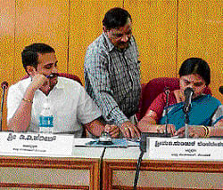Taking stock: ZP president Manjula reviews the file recommending the suspension of  Social Welfare officer, Anand on Tuesday at a progress review meeting in Kolar. Dh Photo