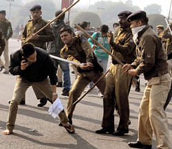 Police charging a student during a protest to demand justice for the gang rape victim at Vijay chowk in New Delhi on Saturday. PTI