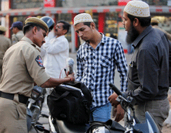 An Indian police officer checks the bags of motorists at a street after security was enhanced following Thursdays dual bomb attacks in Hyderabad, India, Sunday, Feb. 24, 2013. Indian police are investigating whether the Indian Mujahideen, a shadowy Islamic militant group thought to have links with militants in neighboring Pakistan was responsible for the attack that killed 16 people. AP Photo