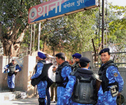 New Delhi: RAF personnel guard outside a police station in the tense Mangolpuri area of New Delhi on Saturday after protests against the rape of a 7-year-old girl. PTI Photo