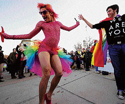 A man dressed in drag known as Queen, dances with a demonstrator in front of the US Supreme Court in  Washington DC on Tuesday. AFP photo