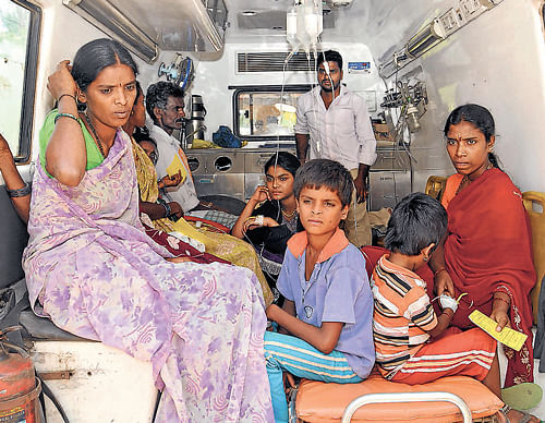 Dreaded fever: Children from D Saalundi village, who have taken ill, being shifted to  hospitals in Mysore after dengue deaths were reported, on Friday. dh photo
