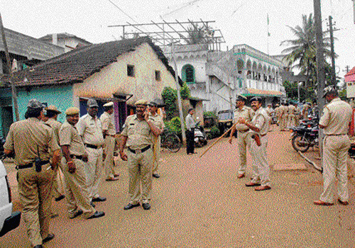 Policemen on guard at Rajahams Galli in Belgaum, following a clash between two groups over putting up banners on the eve of Ganesha festival on Sunday. DH photo