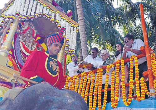 Centenarian lexicographer G Venkatasubbaiah offers floral tributes to the idol of Goddess Chamundeshwari, mounted on elephant Abhimanyu during Jamboo Savari of Srirangapatna Dasara, in Mandya district, on Monday. MP Ramya and Housing Minister M H Ambareesh are seen.