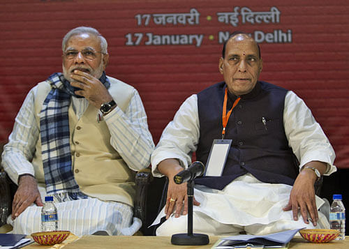India's main opposition Bharatiya Janata Party (BJP) Prime Ministerial candidate and Gujarat state Chief Minister Narendra Modi, left, and party President Rajnath Singh attend the National Executive meeting in New Delhi, India, Friday, Jan. 17, 2014. The party will discuss at the meeting Friday political and economic resolutions which will be put forth for consideration at the party's two-day long National Council meeting beginning Saturday. (AP Photo/Tsering Topgyal)