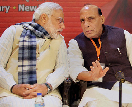 BJP President Rajnath Singh with Gujarat Chief Minister and BJP's PM candidate Narendra Modi at the party's National Executive meeting in New Delhi on Friday. PTI Phot