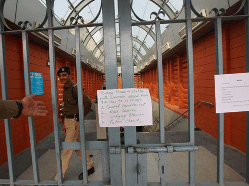 Security personnel closing the gate of Central Secretariat metro station in New Delhi on Monday. Several metro stations were closed due to AAP dharna. PTI Photo