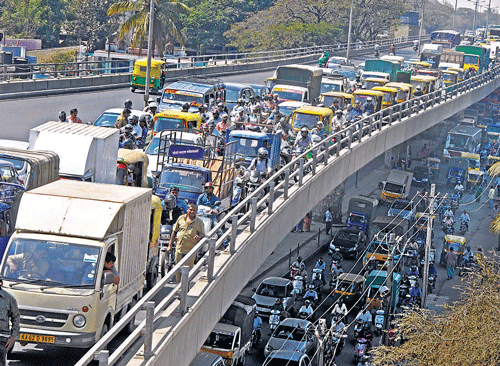 bumper-to-bumper: Vehicles pile up on the Mysore Road flyover on account of the asphalting of the stretch between  Goods Shed Road and City Market. dh Photo
