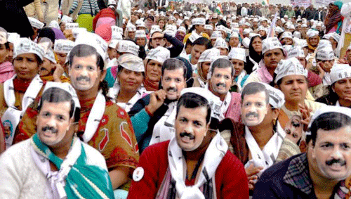 Supporters of AAP wear masks of their leader Arvind Kejriwal at an election rally in Rohtak, Haryana on Sunday. PTI Photo