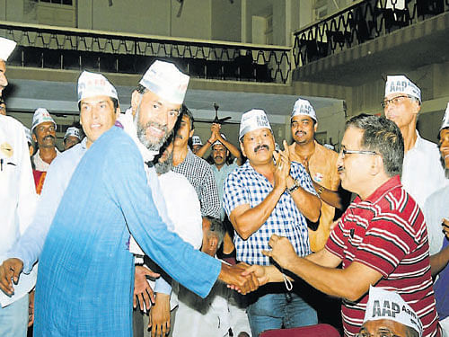 AAP leader Yogendra Yadav is greeted by party supporters at Town hall in Mangalore on Sunday. DH Photo