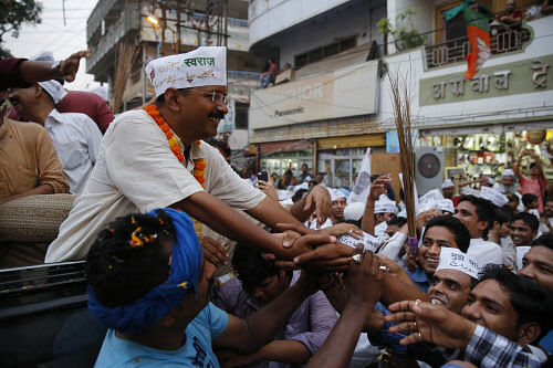 Aam Aadmi Party chief Arvind Kejriwal shakes hands with supporters at an election rally in Varanasi, Uttar Pradesh, on Friday. AP
