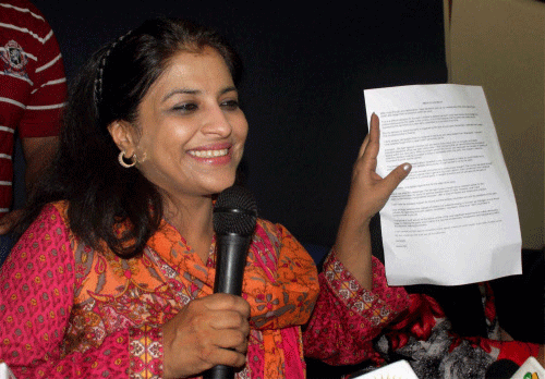 Shazia Ilmi, one of the founder members of the Aam Aadmi Party, showing her resignation letter at a press conference in New Delhi on Saturday. Ilmi resigned from all party posts. PTI Photo