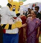 As large as life: Prime Minister Manmohan Singhs wife Gursharan Kaur meets Shera, the mascot for Delhi 2010 Commonwealth Games, during a winter carnival, in New Delhi on Sunday. pti