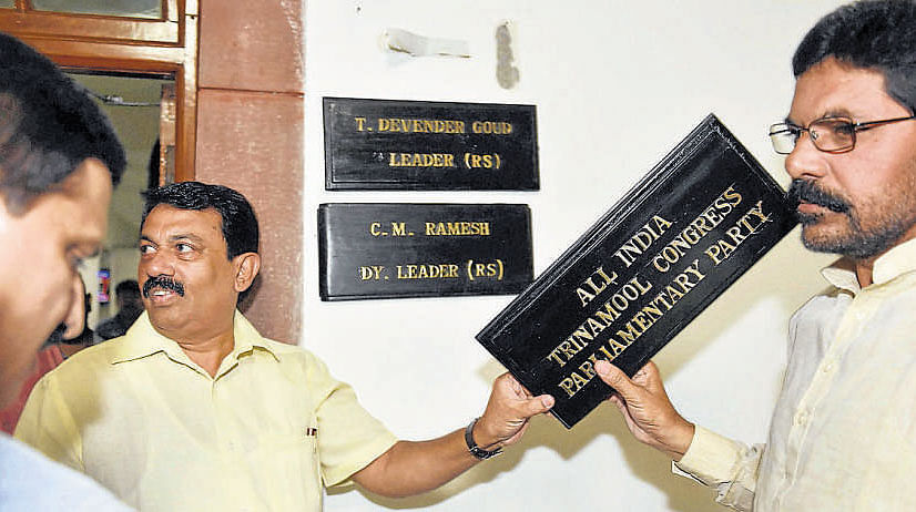 TDP MPs holding a nameplate of TMC that was put up at Room No. 5 in Parliament in New Delhi on Tuesday. PTI