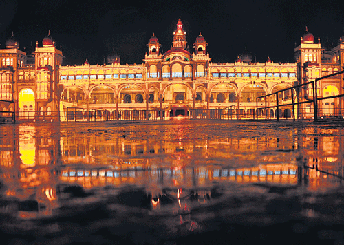 reflection of beauty: This picture of the world famous Amba Vilas Palace and its reflection in the rain water was taken by Deccan Herald/Prajavani photographer to mark World Photography Day, in Mysore, on Monday. DH photo by Irshad Mahammad
