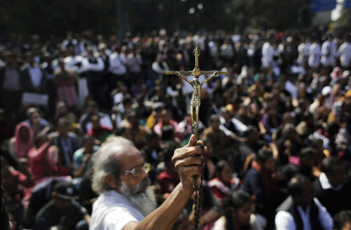 Scores of members of the Christian community and social activists staged a protest outside the Delhi Police headquarters here this morning over alleged police inaction in the case of the fire which yesterday gutted a church in northeast Delhi's Tahirpur area. AP file photo