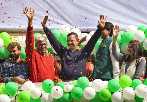 Arvind Kejriwal  waves to the crowd as his party looks set for a landslide party in New Delhi. AP Photo