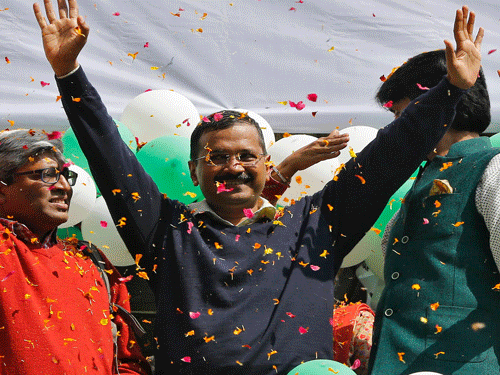 AAP chief and its chief ministerial candidate for Delhi Kejriwal waves to his supporters in New Delhi. Reuters Photo