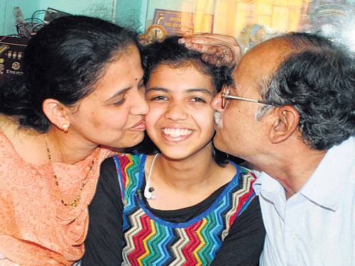 Rituparna (centre) with her parents at their residence in Belagavi. She has secured second highest marks in SSLC  examination.