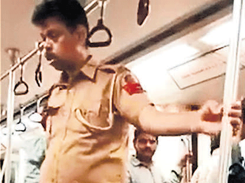 The drunk policeman was seen struggling to even stand straight, and fell down when the Metro stopped. Video Grab