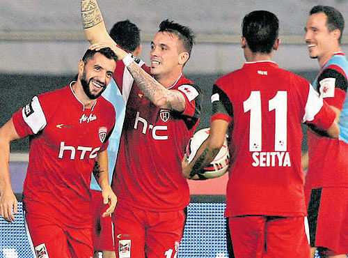 SAVIOUR NorthEast United FC's Simao Sabrosa (left) celebrates with team-mate Nicolas Velez (centre) after scoring the equaliser against Delhi Dynamos on Tuesday. ISL MEDIA