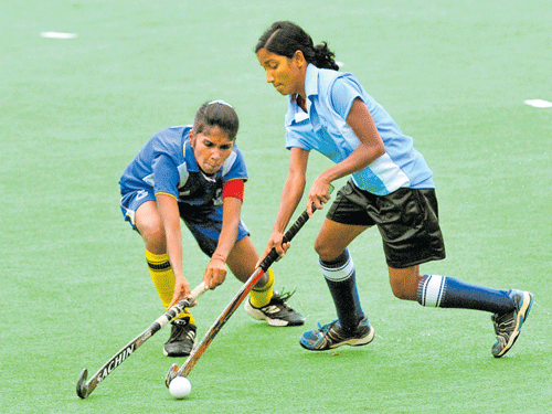 Keen tussle A Vismaya (right) of University of Calicut and K Minaga of Periyar vie for the ball on Wednesday. DH PHOTO