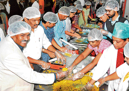 Director CFTRI Prof Ram Rajashekaran (extreme left) and students pack food items to be sent to Chennai flood victims in Mysuru on Friday. dh photo