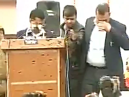 The woman, who appeared to be in her 20s, came close to the lectern when Kejriwal was delivering his speech and showed some papers to him. screen grab