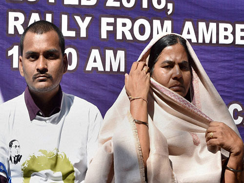 Radhika Vemula, flanked by her other son Raja, said BJP will be 'decimated to the ground' if Prime Minister Narendra Modi does not take any action against Irani and her ministerial colleague Bandaru Dattatreya who had written multiple letters to her seeking action against Rohith, alleging anti-national activities. PTI Photo.