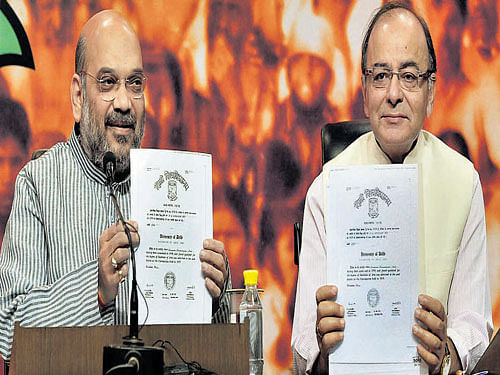 BJP president Amit Shah and Finance Minister Arun Jaitley show degree certificates of Prime Minister Narendra Modi at the BJP headquarters in New Delhi. PTI