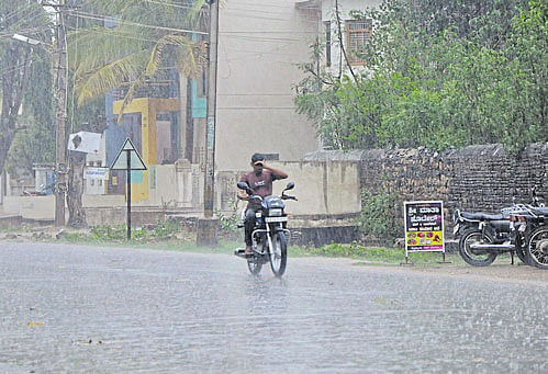 A motorcyclist braves the rain in Gadag on Monday. Dh&#8200;Photo