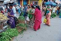 Women seen purchasing mango and neem leaves on the eve of Ugadi in Chikmagalur on  Monday.  DH Photo
