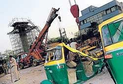 Damaged autorickshaws at a Delhi Metro Rail construction site in New Delhi on Wednesday. AFP