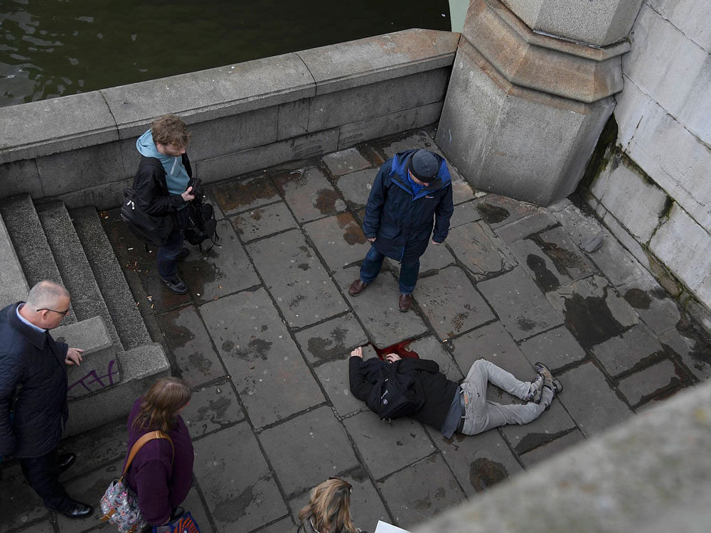 A Reuters photographer saw at least a dozen people injured on Westminster Bridge and photographs showed people lying on the ground, bleeding heavily. Reuters Photo