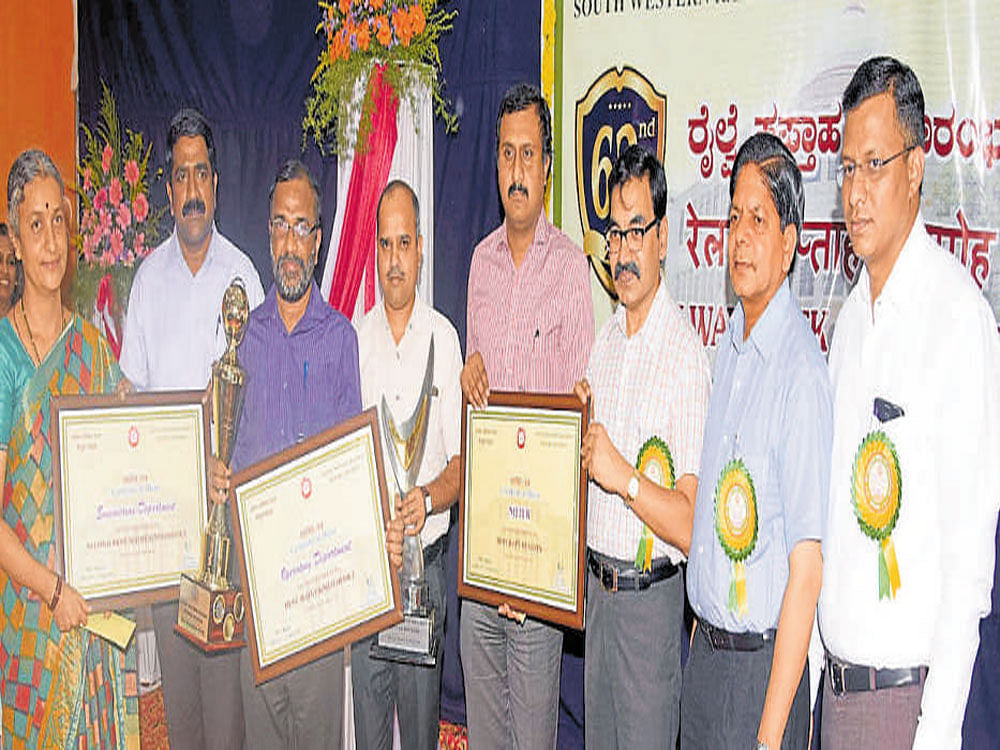 During the 62nd Railway Week celebrations, South Western Railway Divisional Railway Manager Atul Gupta distributes certificates to Railway employees for their outstanding  contribution. The celebrations were held at Railway Kalyan Mantap in Vontikoppal, Mysuru on Wednesday. DH photo