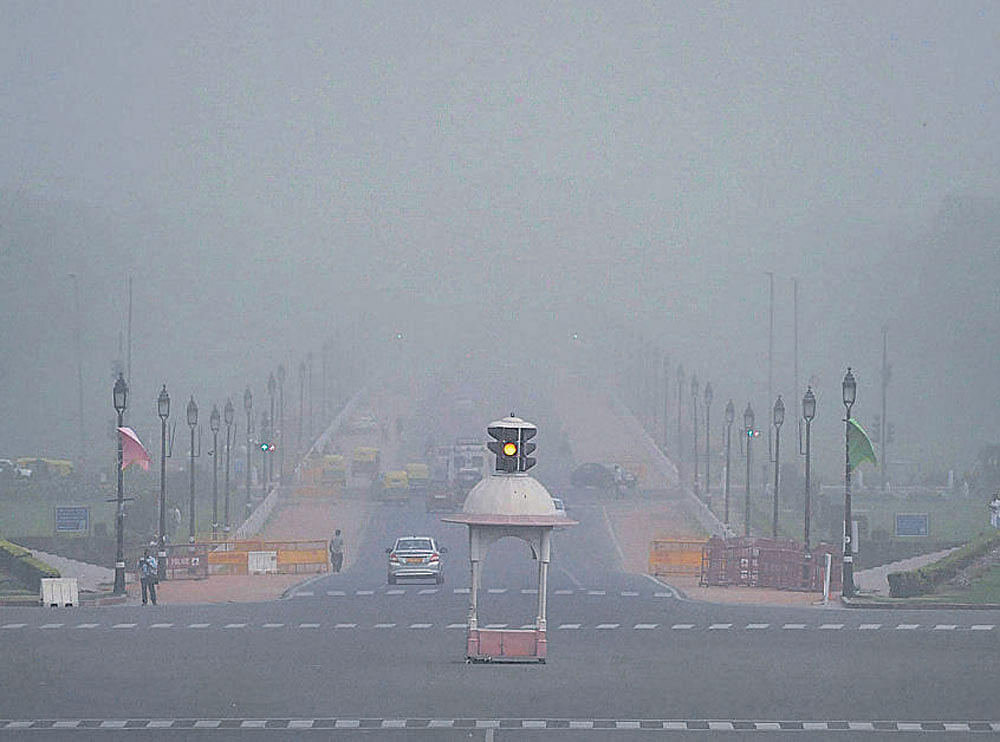 capital storm: (Top) Vehicles plying along Rajpath during a dust storm that hit several parts of Delhi on Saturday. Press Trust of India