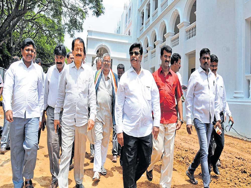 PWD and District in-charge Minister Dr H C Mahadevappa inspects ongoing construction works at Maharani's College for Women on Valmiki Road in Mysuru on Monday. MLA Vasu is also seen. DH photo