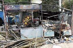 Sugar cane juice stall and a pan shop that were gutted in Shimoga on Wednesday.  DH Photo