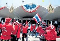 Dissent in the air: A protester waves a Thai national flag inside parliament in Bangkok on Wednesday. REUTERS