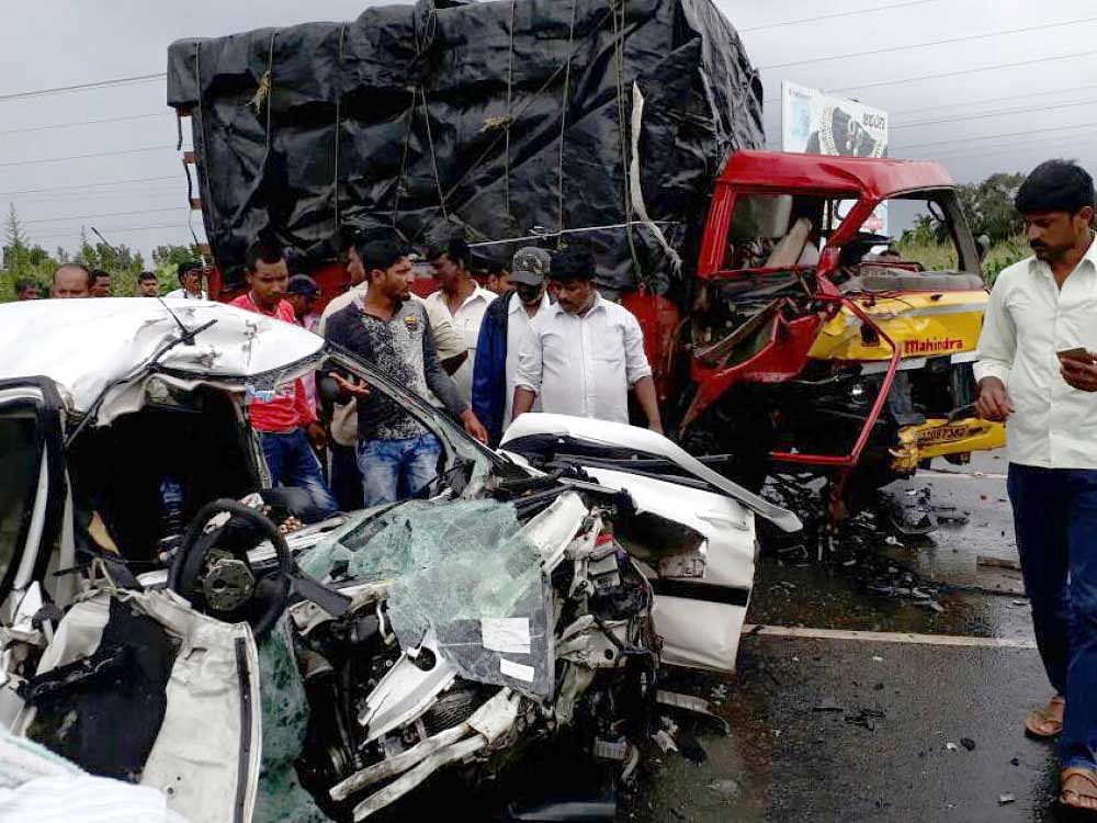 The mangled remains of the car that hit a lorry near Ayanur in Shivamogga taluk on Monday. DH photo